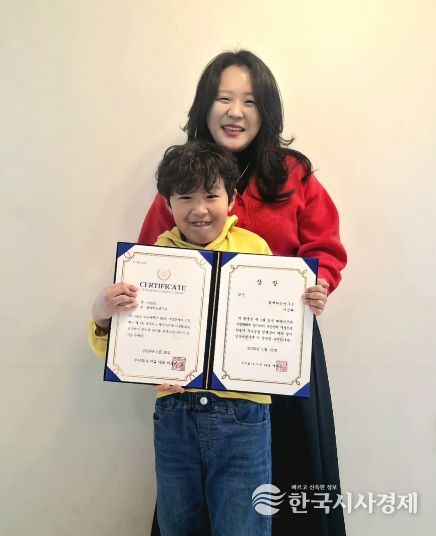 함께하는연구소 박현지 소장(뒤)과 연구소 이용 아동 이건희 군이 「제1회 경북 베리어프리 사생대회」 수상을 기념해 촬영한 모습